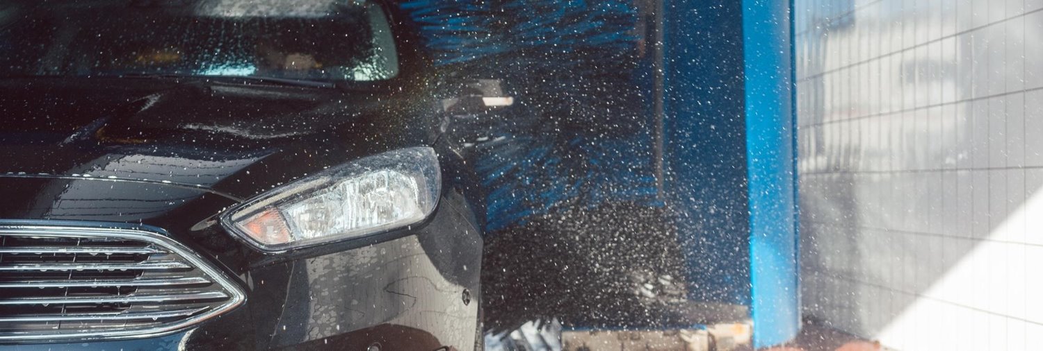 black car coming out of a car wash