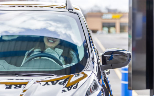 woman at car wash enjoying contactless transaction