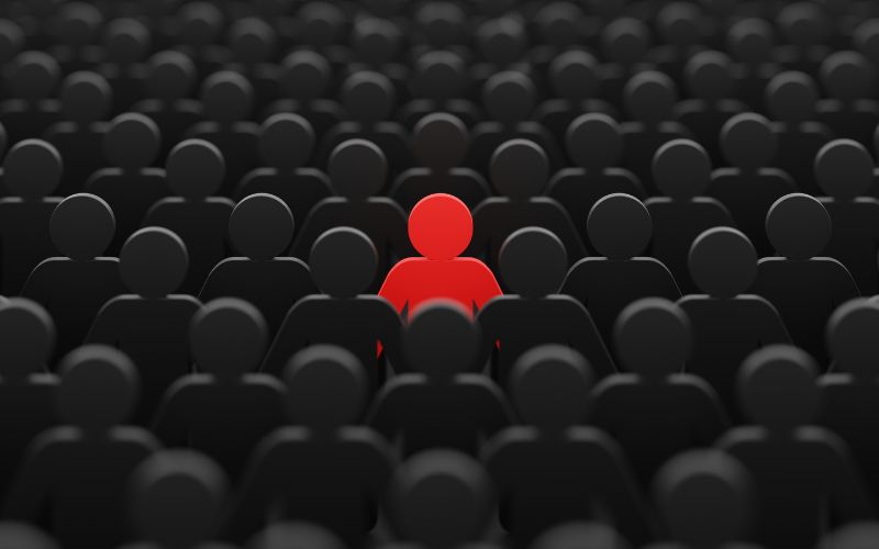 Red character in a crowd of black characters