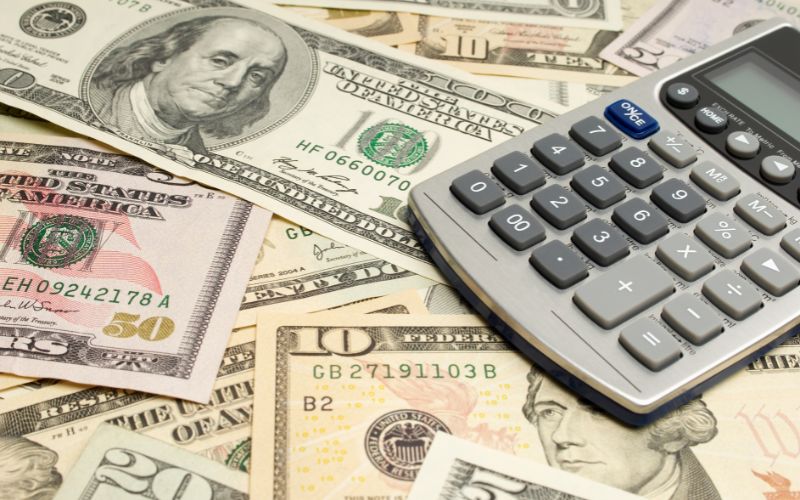Calculator and dollar bills