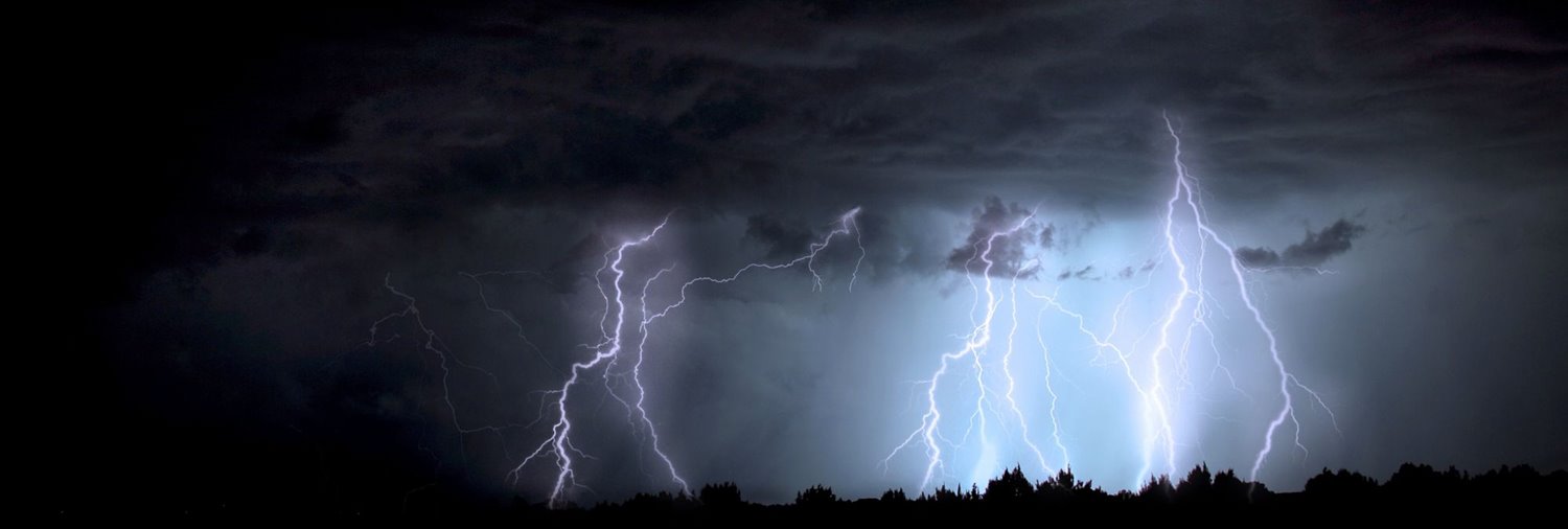 Dark sky with clouds and several lightning bolts