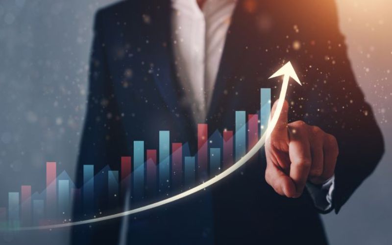 upward bar graph overlay in front of a man pointing