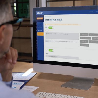 man looking at computer screen displaying patheon car wash management platform