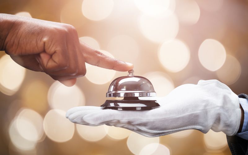 Gloved hand holding a bell