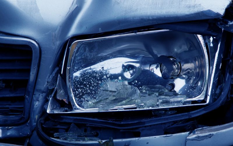 wrecked drivers side headlight on a car