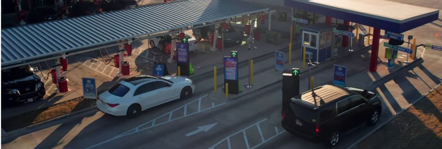 wide images  of cars going through lanes at car wash