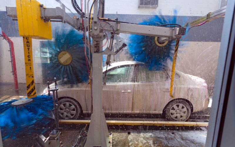 white car going through a car wash tunnel
