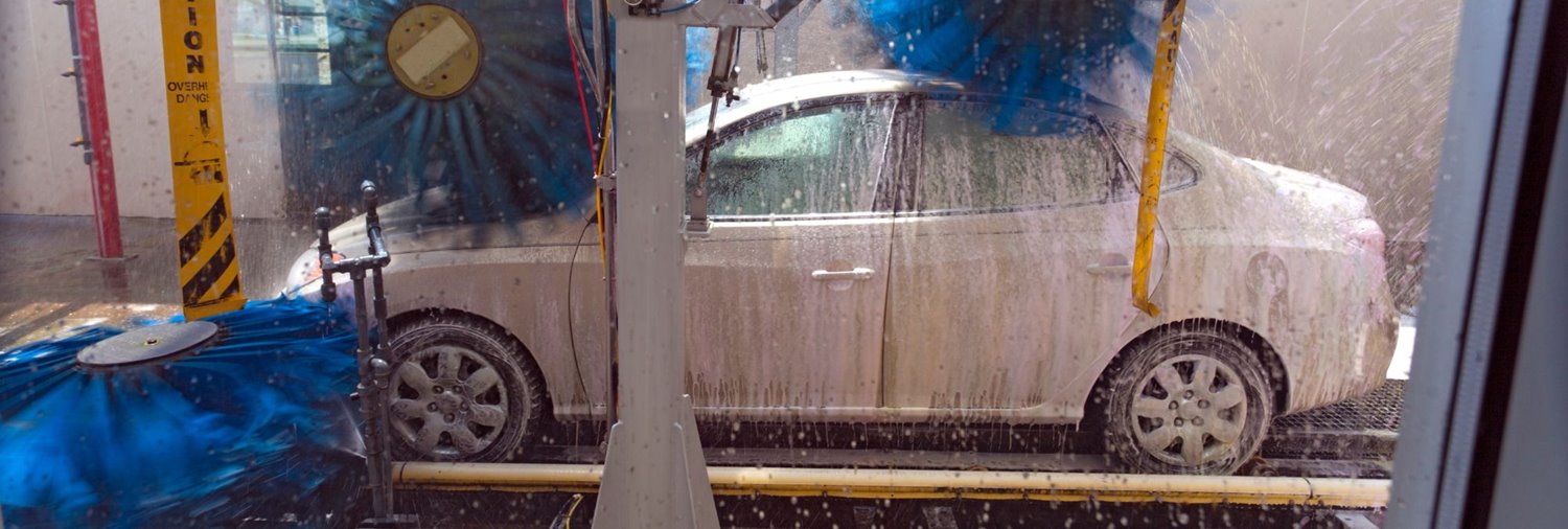 white car going through a car wash tunnel