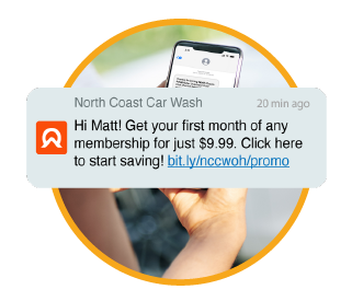 isolated graphic of a text message from a car wash overlaid on an image of someone holding a mobile phone